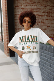 Ivory Miami Hurricanes Unity Oversized Crewneck Tee - Front Graphic Detail On Model Brick Wall | Gameday Couture - SOHO