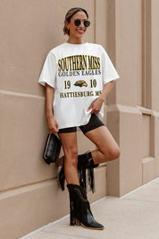 Ivory Southern Miss Golden Eagles Unity Oversized Tee - On Model Front View Leaning Against Wall | Gameday Couture - SOHO