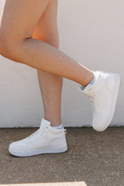 White Step Up Midtop Sneakers - Side Angle On Model | Gameday Couture - SOHO