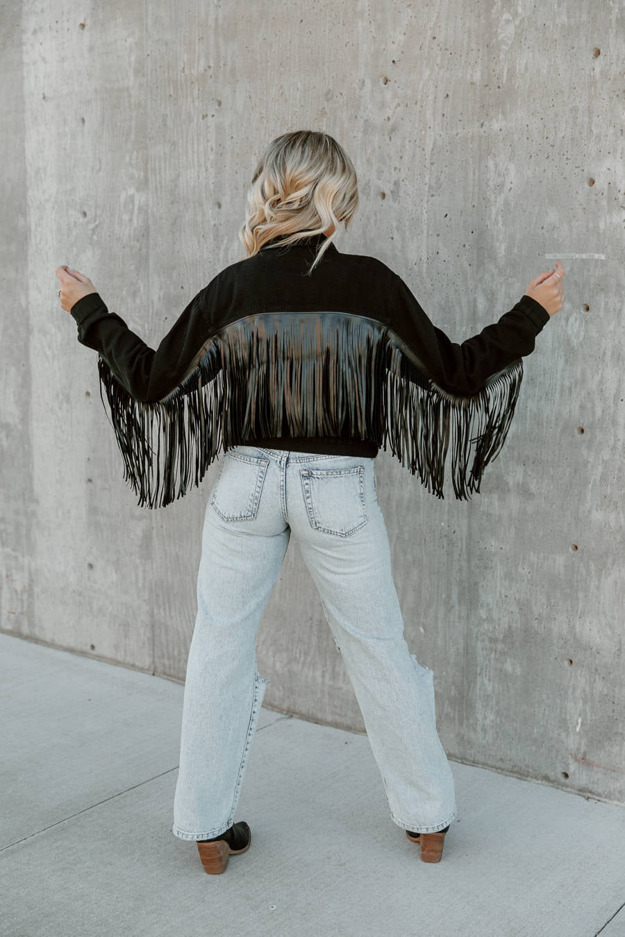 JOLENE CROPPED FRINGE DENIM JACKET IN BLACK - Back View Model | Gameday Couture - SOHO